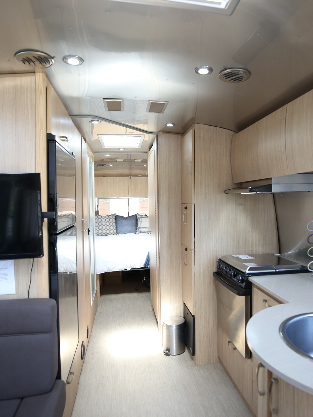 The interior hallway of the Airstream lounge looking through to the bed