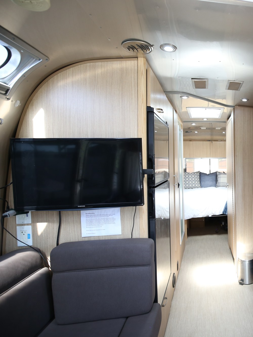 A mounted flat-screen TV in the Airstream lounge