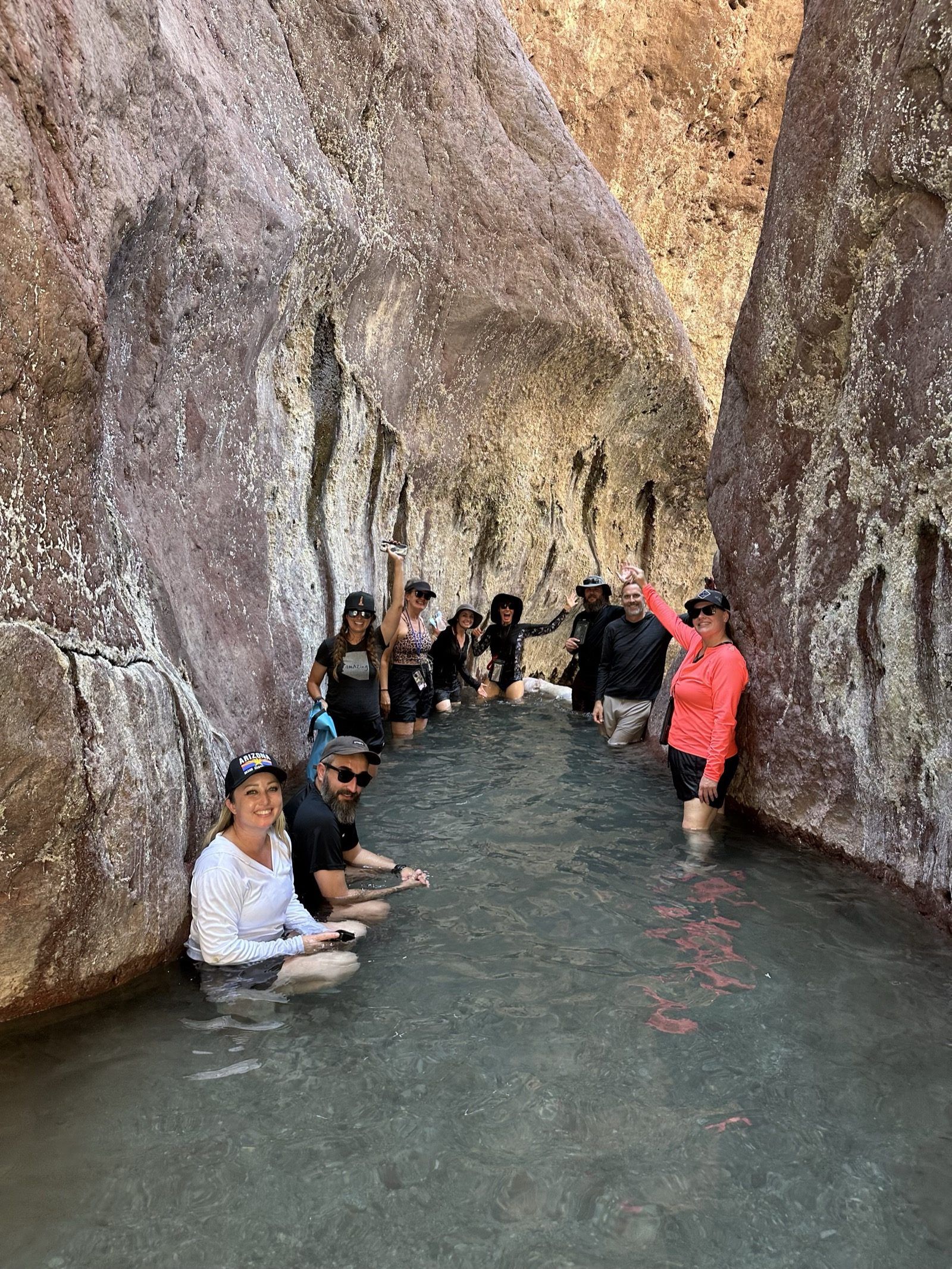 Group soaking in the Black Canyon hot springs on a Colorado River paddleboard adventure